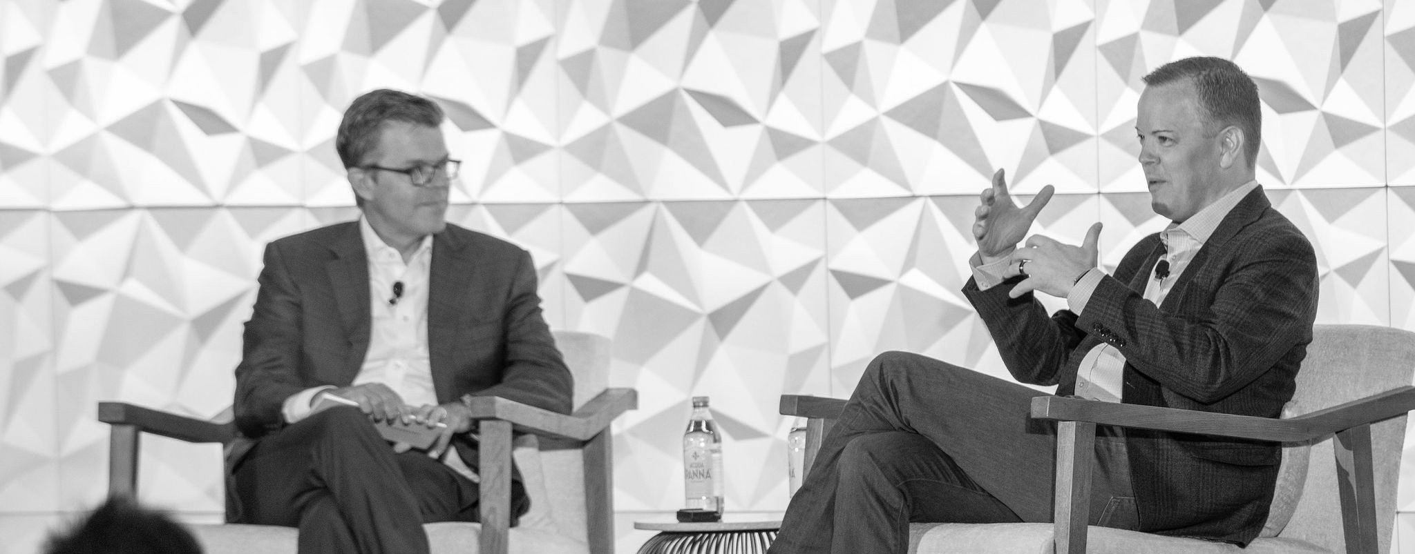 Aaron Klein speaking onstage during a live conversation